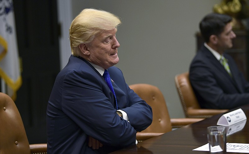 President Donald Trump pauses as he is asked a question by a reporter as they are leaving the Roosevelt Room of the White House in Washington, Tuesday, Nov. 28, 2017, during a meeting with Republican congressional leaders. (AP Photo/Susan Walsh)