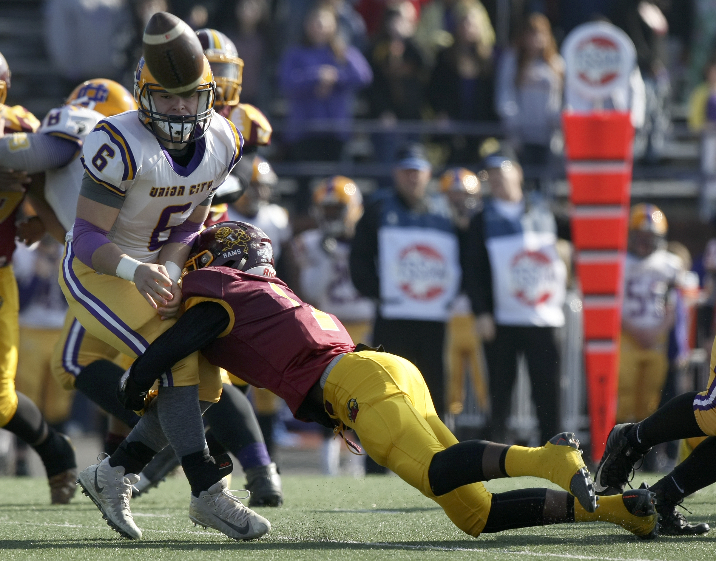 Union City's Braxton Waddell (6) pitches the ball as he is hit by Tyner's Martavius Ryals (1) during the Class 2A BlueCross Bowl state championship at Tennessee Technological University's Tucker Stadium on Friday, Dec. 1, 2017 in Cookeville, Tenn.