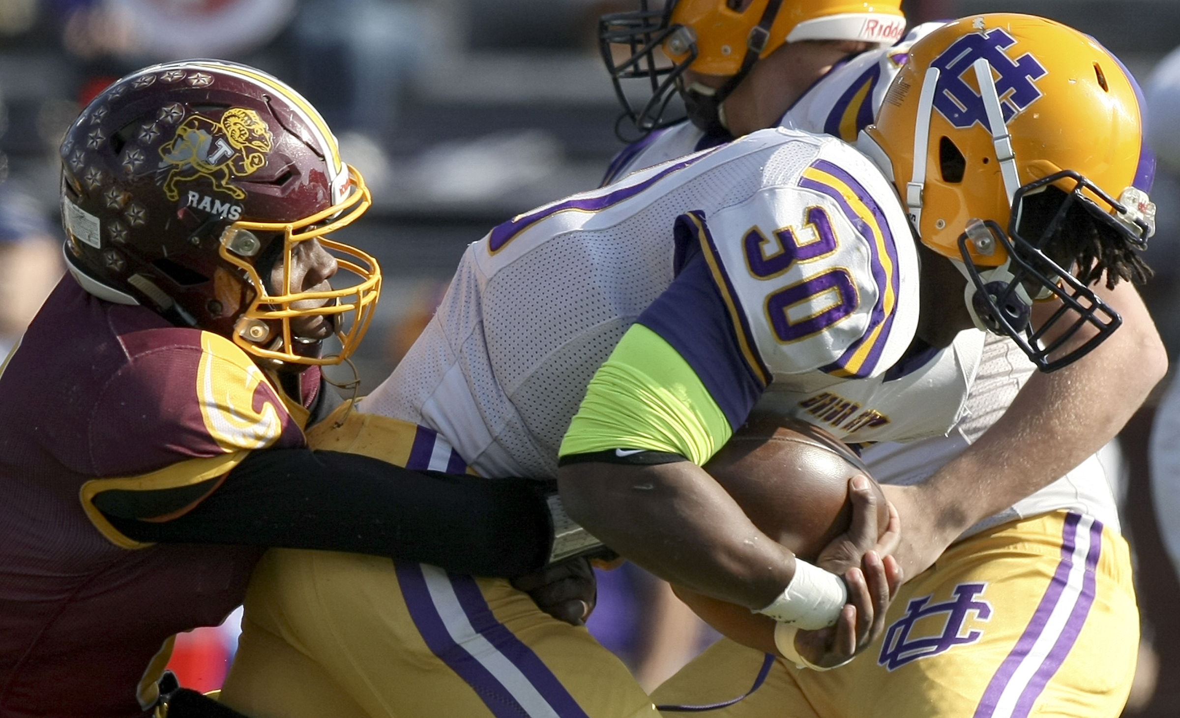 Union City's Trey Jones (30) fights for extra yards as Tyner's Jaylen Bowens (8) tries to stop him during the Class 2A BlueCross Bowl state championship at Tennessee Technological University's Tucker Stadium on Friday, Dec. 1, 2017 in Cookeville, Tenn.