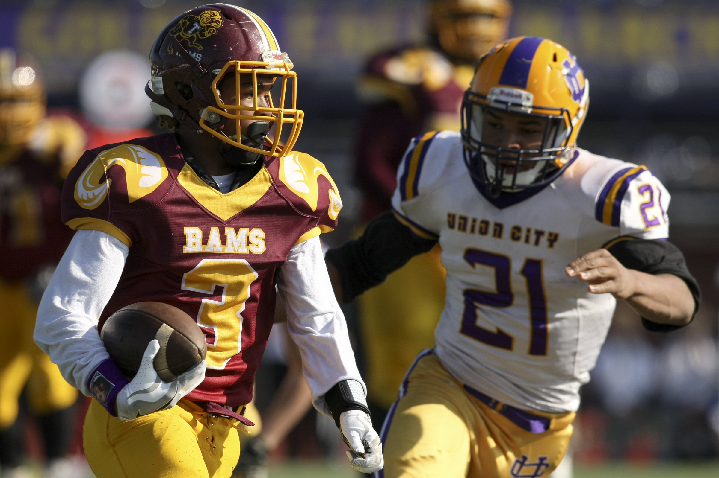 Tyner's Donald Cannon (3) carries the ball against Kaleb Craig (21) and Union City during the Class 2A BlueCross Bowl state championship at Tennessee Technological University's Tucker Stadium on Friday, Dec. 1, 2017 in Cookeville, Tenn.