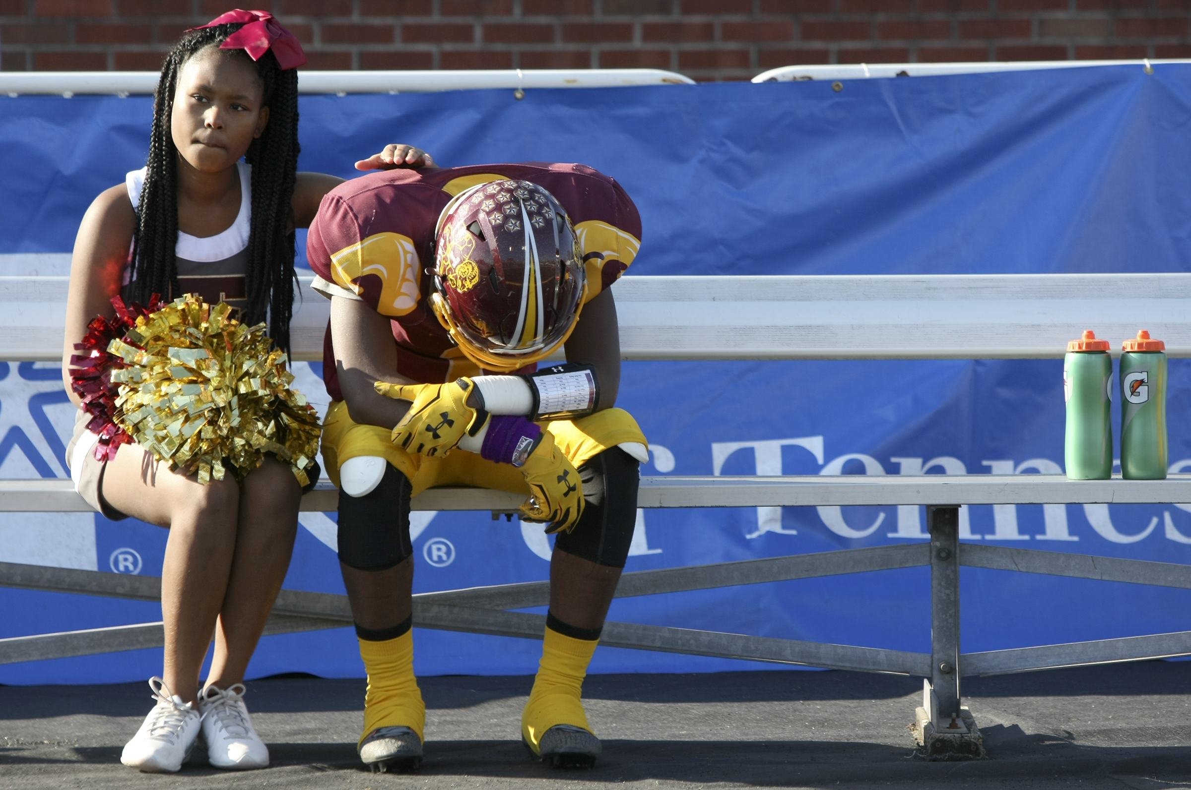 Tyner cheerleader Sharice Delaney comforts Martavius Ryals (1) after losing the Class 2A BlueCross Bowl state championship to Union City in double overtime at Tennessee Technological University's Tucker Stadium on Friday, Dec. 1, 2017 in Cookeville, Tenn.