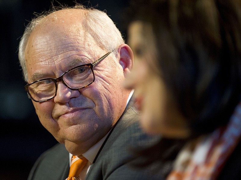 Phillip Fulmer looks over as University of Tennessee Chancellor Beverly Davenport speaks during a press conference, Friday, Dec. 1, 2017, in Knoxville, Tenn., where Fulmer was named athletic director. The university placed former AD John Currie on paid leave amid what has been a tumultuous and embarrassing football coaching search. (Calvin Mattheis/Knoxville News Sentinel via AP)