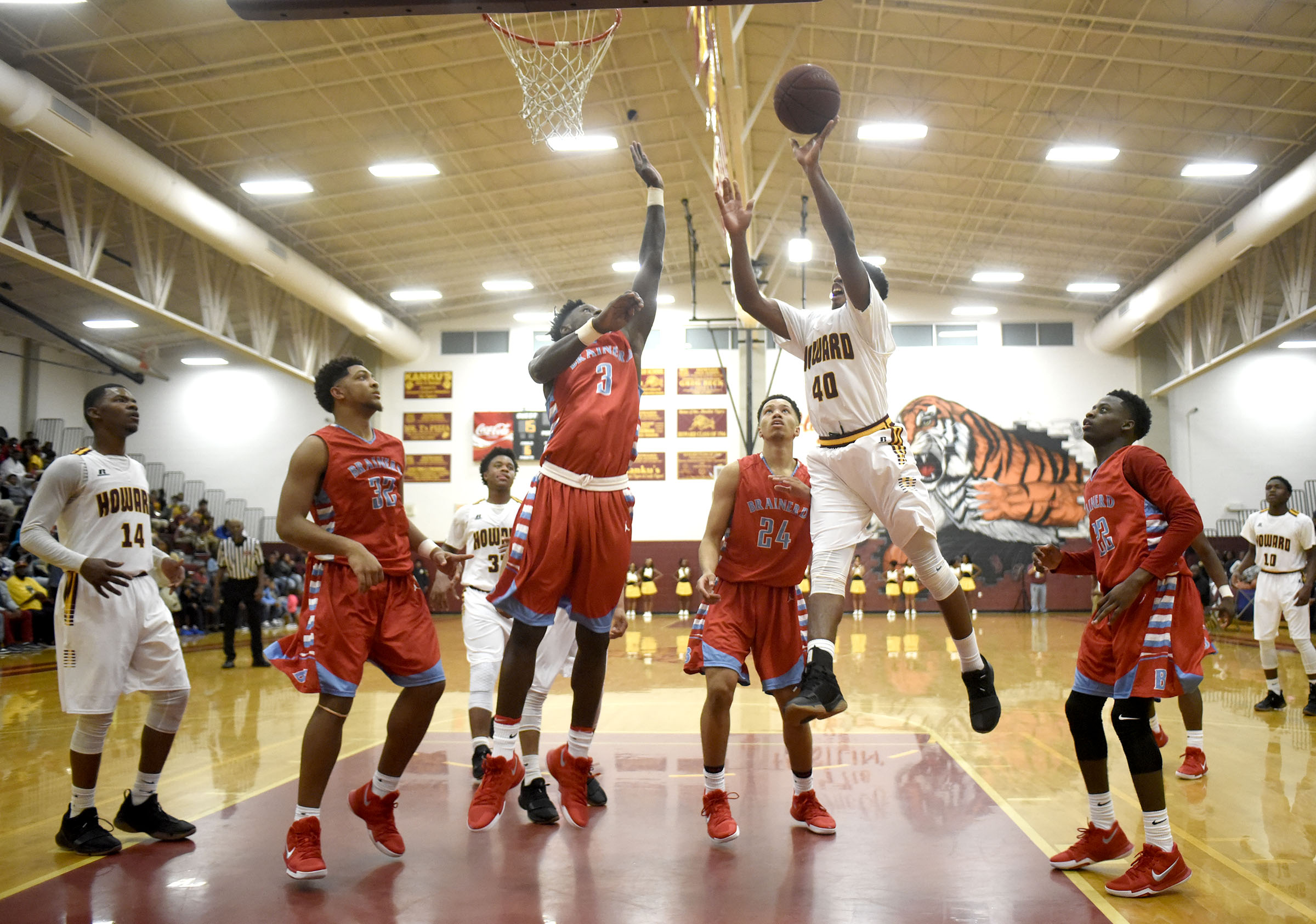 Howard's Telijah Snow (40) shoots under the basket while Brainerd's Joseph Norwood (3) defends. The Brainerd Panthers visited the Howard Hustling Tigers in TSSAA basketball action on December 1, 2017.