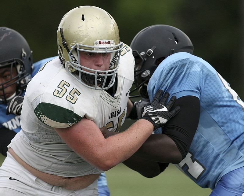 Notre Dame's Sam Stovall (55) gets around a block from Brainerd's JaMichael Wilson (54) during a scrimmage at Central High School's Central Memorial Stadium on Tuesday, Aug. 1, in Harrison, Tenn.