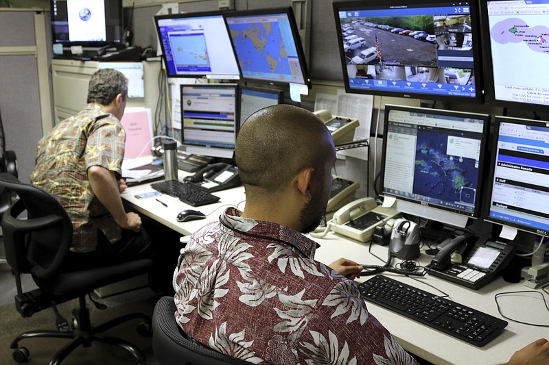 Hawaii Emergency Management Agency officials work at the department's command center in Honolulu on Friday, Dec. 1, 2017.