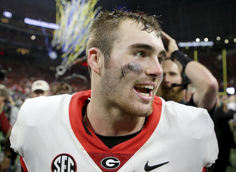 Georgia quarterback Jake Fromm (11) celebrates after defeating Auburn 28-7 to win the Southeastern Conference championship at Mercedes-Benz Stadium on Saturday, Dec. 2, 2017 in Atlanta, Ga.