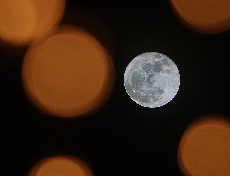 A supermoon is seen between the lights of a Christmas tree in Coolidge Park Sunday, Dec. 3, 2017, in Chattanooga, Tenn. The most recent supermoon was on Nov. 14, 2016.