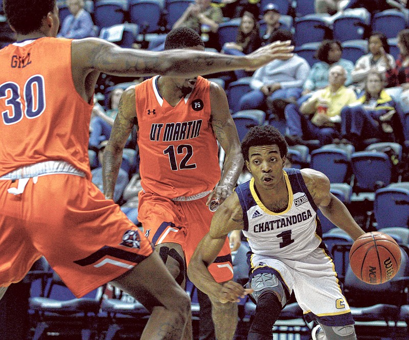 University of Tennessee Chattanooga's Rodney Chatman (1) drives against UT Martin's Fatodd Lewis (12) and Jailen Gill (30) on Saturday. The Chattanooga Mocs took on the UT Martin Skyhawks at McKenzie Arena in Chattanooga, Tenn. on Saturday Dec. 2, 2017. (Photo by Bryant Hawkins)