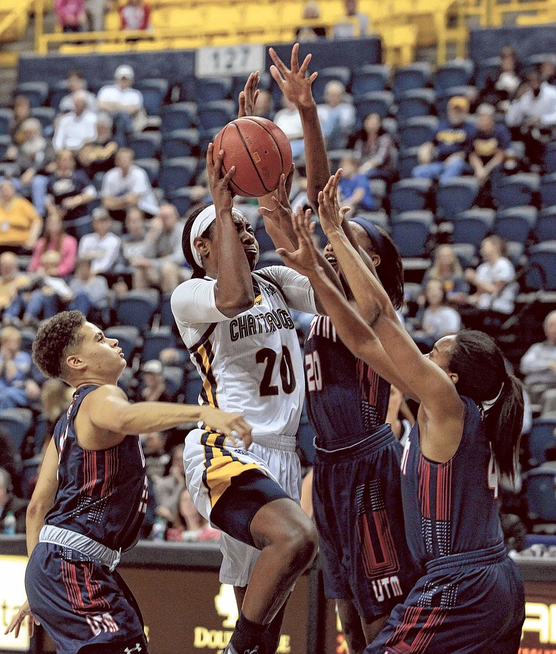 University of Chattanooga's Keiana Gilbert (20) takes a shot over UT Martin defense during their game Saturday. The Chattanooga Mocs took on The UT Martin Skyhawks on Saturday, Dec. 2 at McKenzie Arena in Chattanooga, Tenn. The Mocs rallied during overtime to defeat The Skyhawks 87-82. (Photo by Bryant Hawkins)