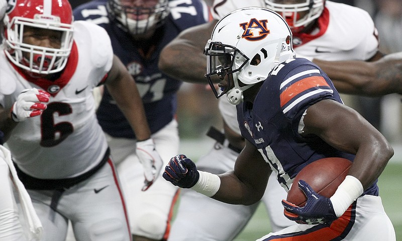 Georgia junior inside linebacker Natrez Patrick (6), shown eyeing Auburn running back Kerryon Johnson in Saturday's SEC title game, was arrested late Saturday night along with Bulldogs junior receiver Jayson Stanley.