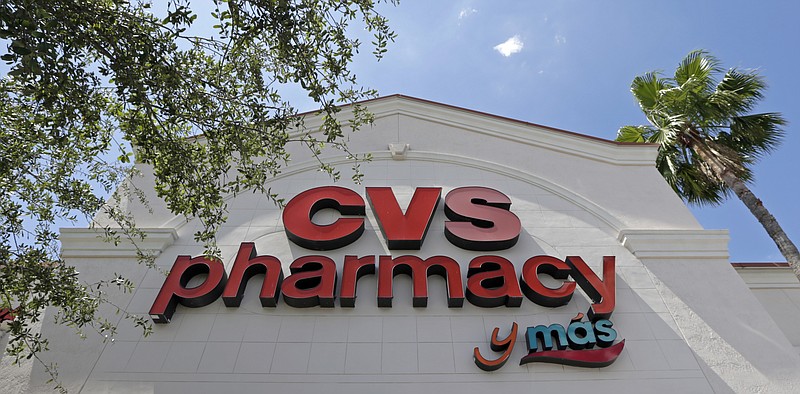 This May 15, 2017, file photo, shows a CVS pharmacy sign at a store in Hialeah, Fla. CVS will buy insurance giant Aetna in a roughly $69 billion deal that will help the drugstore chain provide more health care and keep a key client, according to a person with knowledge of the matter. (AP Photo/Alan Diaz, File)