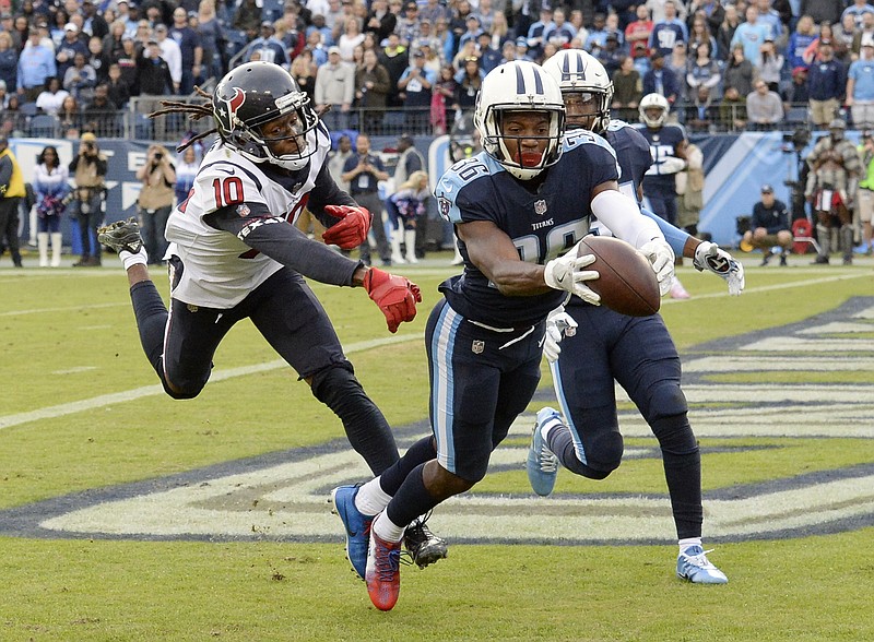 Tennessee Titans cornerback LeShaun Sims (36) intercepts a pass in the end zone intended for Houston Texans wide receiver DeAndre Hopkins (10) near the end of the fourth quarter of an NFL football game Sunday, Dec. 3, 2017, in Nashville, Tenn. (AP Photo/Mark Zaleski)