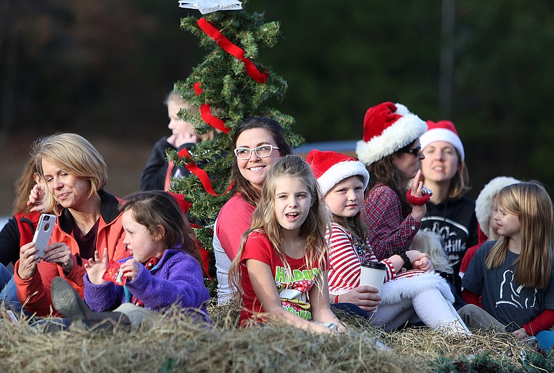 Individuals with the Hidden Hills Farm and Saddle Club make their way down Little Debbie Parkway on a float during the Collegedale-Ooltewah Spirit of Christmas Parade Sunday, Dec. 3, 2017 in Collegedale, Tenn. A variety of clubs, businesses and organizations participated in this year's parade. 