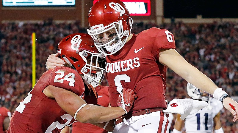 Oklahoma quarterback Baker Mayfield, shown here celebrating with running back Rodney Anderson, has thrown 41 touchdowns and only five interceptions in his final season with the Sooners.