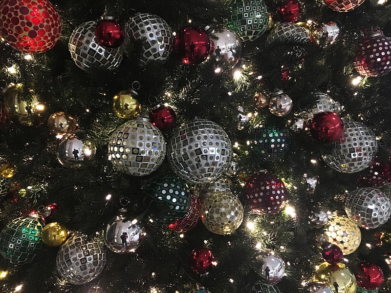 In this Friday, Dec. 1, 2017, photo, ornaments hang on a Christmas tree on display in New York. The office holiday party is getting shaken up as reports of sexual misconduct by famous and powerful men have many companies thinking harder about how to stop bad behavior in the workplace. A survey shows fewer companies will serve alcohol this year than last year, but HR experts say that's not enough. (AP Photo/Swayne B. Hall)