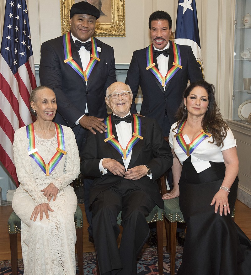 Front row from left, 2017 Kennedy Center Honorees Carmen de Lavallade, Norman Lear, and Gloria Estefan, back row from left, LL Cool J, and Lionel Richie are photographed following the State Department dinner for the Kennedy Center Honors, Saturday, Dec. 2, 2017, in Washington. (AP Photo/Kevin Wolf)