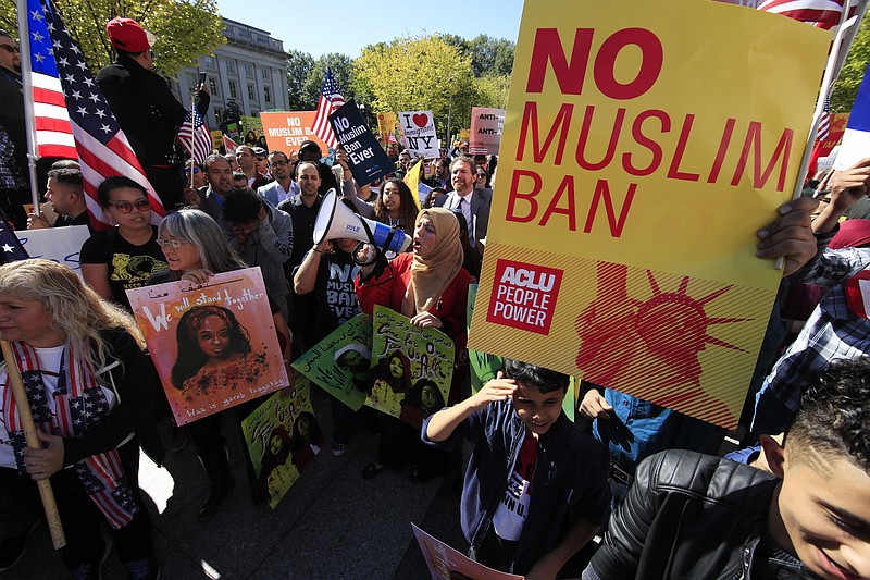 In this Oct. 18, 2017, file photo, protesters gather at a rally in Washington. The Supreme Court is allowing the Trump administration to fully enforce a ban on travel to the United States by residents of six mostly Muslim countries. The justices say in an order on Dec. 4, that the policy can take full effect even as legal challenges against it make their way through the courts. (AP Photo/Manuel Balce Ceneta, File)