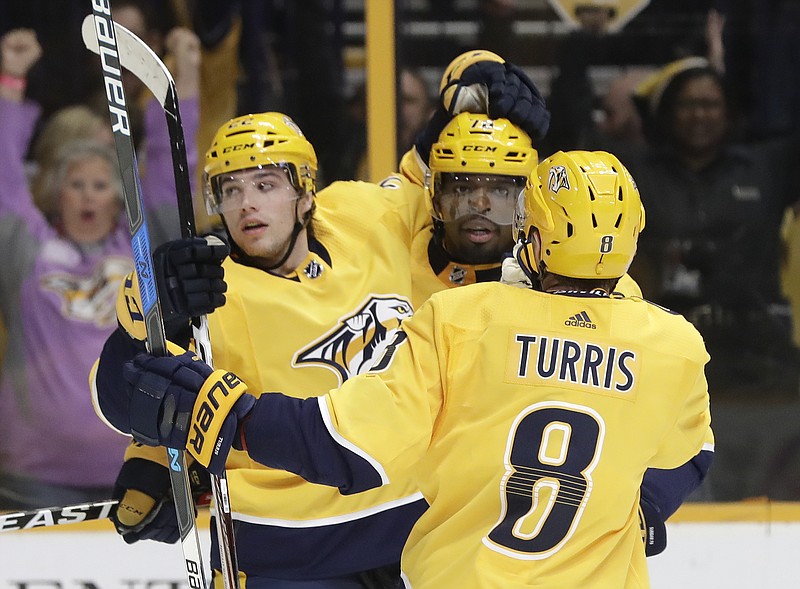 Nashville Predators left wing Kevin Fiala (22), of Switzerland, celebrates with P.K. Subban (76) and Kyle Turris (8) after Fiala scored a goal against the Boston Bruins in the second period of an NHL hockey game Monday, Dec. 4, 2017, in Nashville, Tenn. (AP Photo/Mark Humphrey)