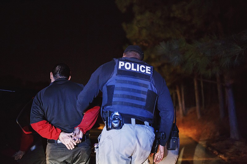 Immigration and Customs Enforcement officers arrest an illegal immigrant in Norcross, Ga., a suburb of Atlanta, in October.