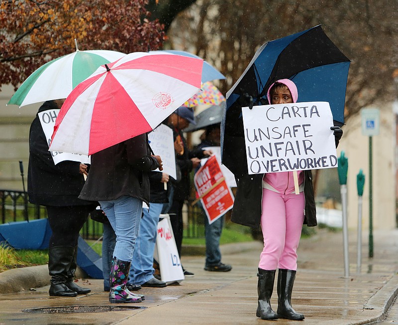 Amalgamated Transit Union Local 1212 President Kathryn Smith holds a sign during a CARTA Transit workers rally Tuesday, Dec. 5, 2017 outside Chattanooga City Hall in downtown Chattanooga, Tenn. CARTA Transit workers were protesting because they said workers are being forced to work overtime beyond their physical limits, are being discriminated against by management and forced to operate unsafe vehicles. Smith has been working for CARTA for 30 years. 