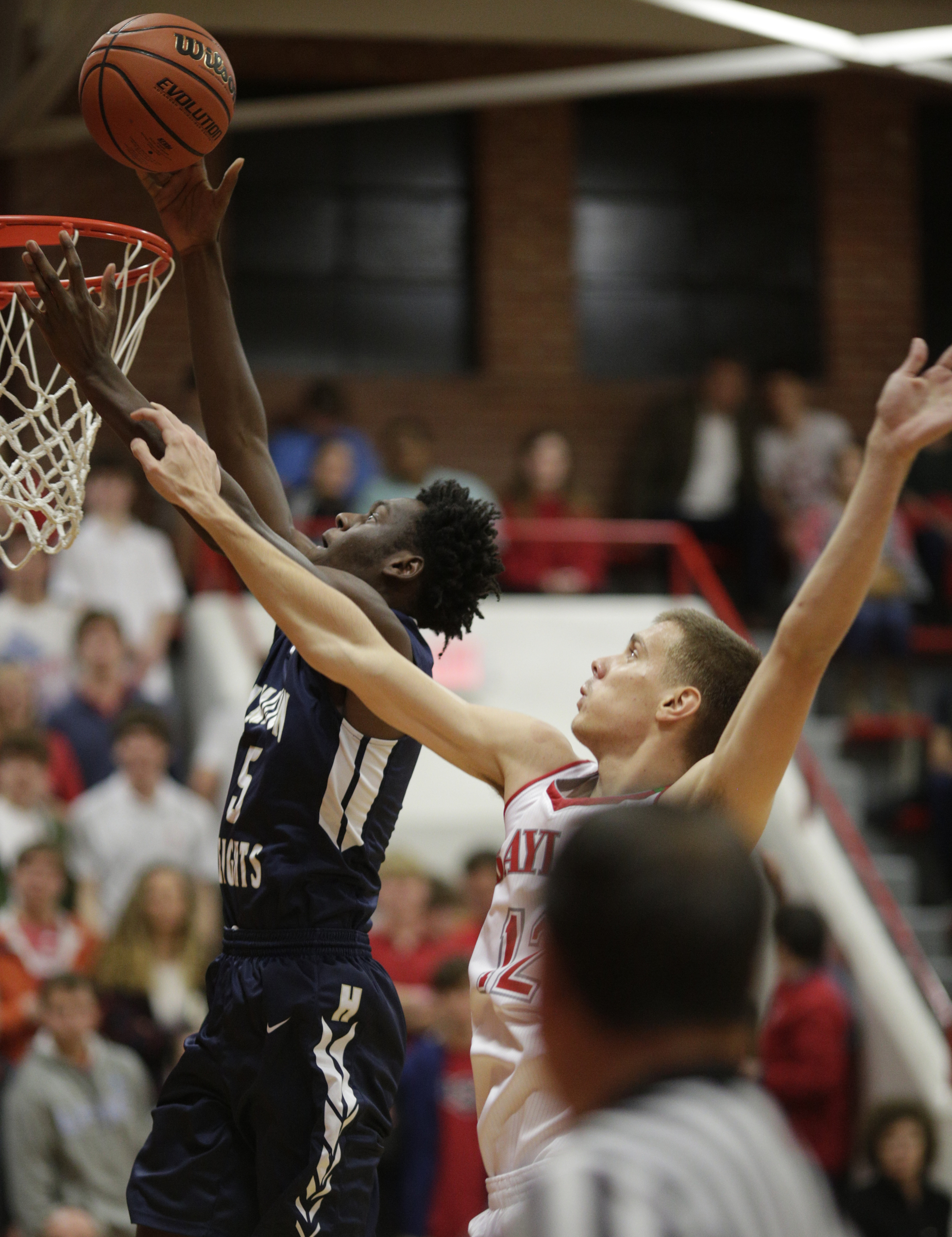 Hamilton Heights' Tre Edwards shoots ahead of Baylor's Boris Ristanovic during their prep basketball game at Baylor School on Tuesday, Dec. 5, 2017, in Chattanooga, Tenn.
