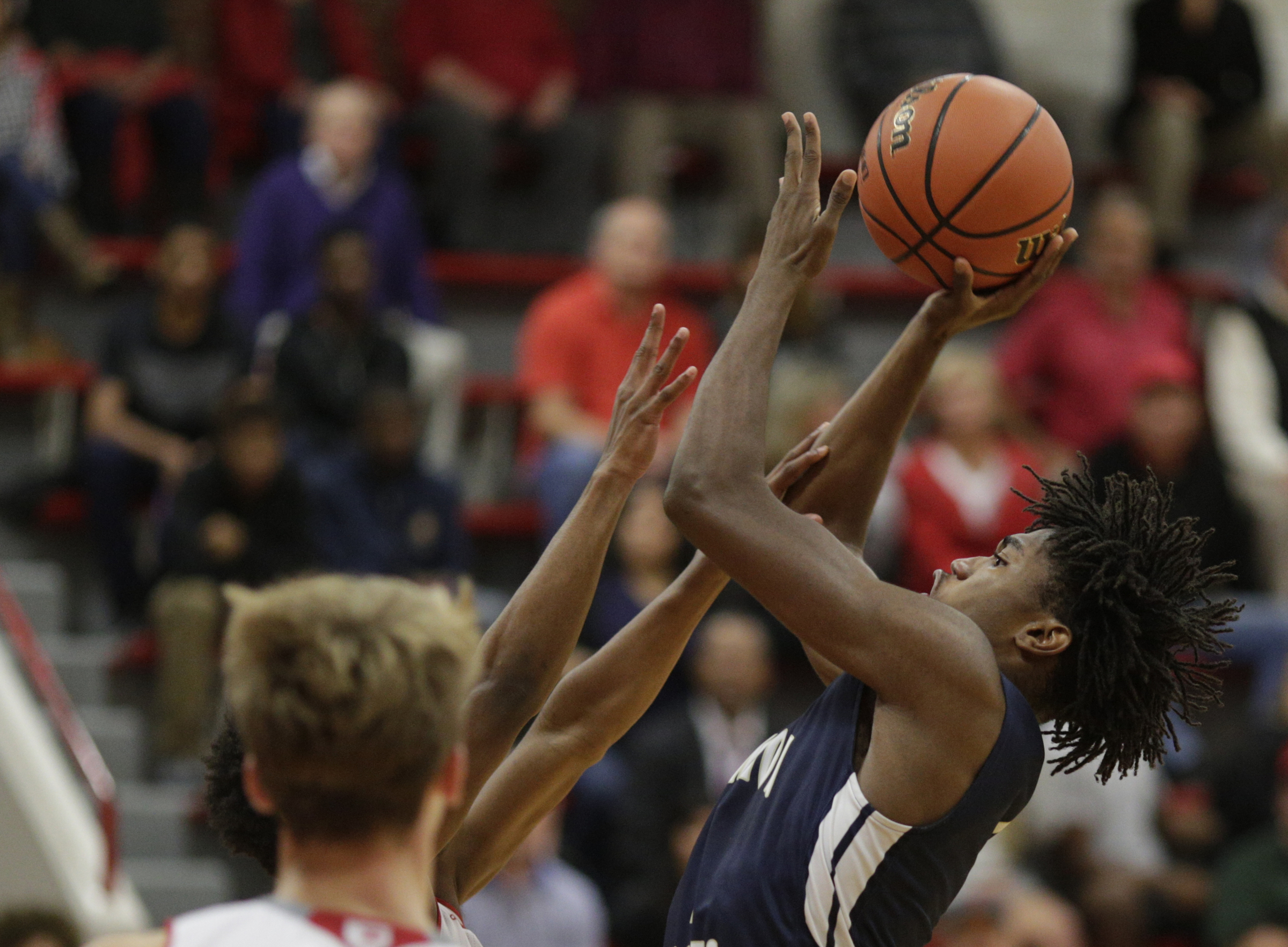 Hamilton Heights' Keavaughn Ellis shoots into Baylor's Beyuan Hendricks during their prep basketball game at Baylor School on Tuesday, Dec. 5, 2017, in Chattanooga, Tenn.