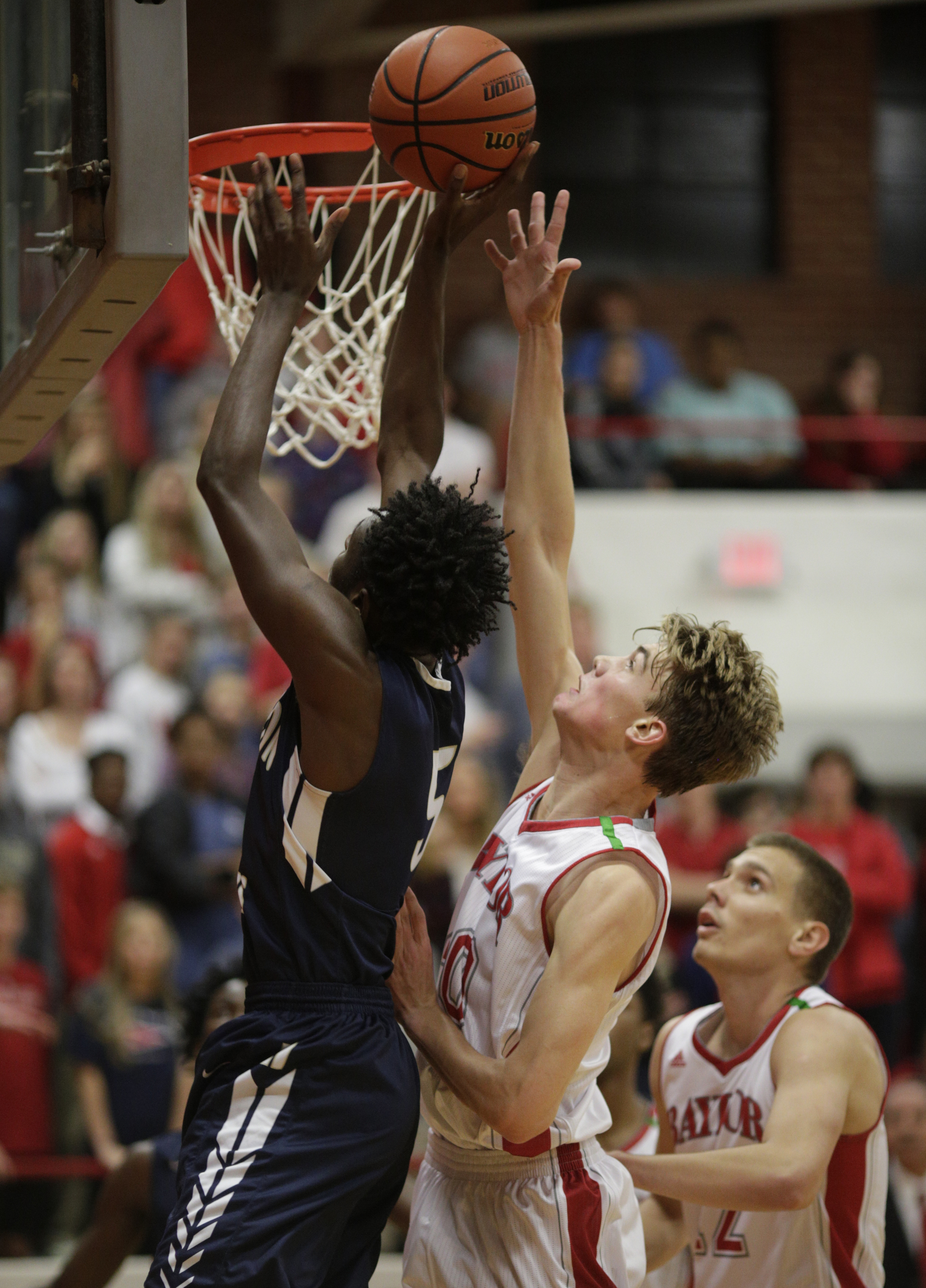 Hamilton Heights' Tre Edwards, left, shoots ahead of Baylor's Patton Ford during their prep basketball game at Baylor School on Tuesday, Dec. 5, 2017, in Chattanooga, Tenn.