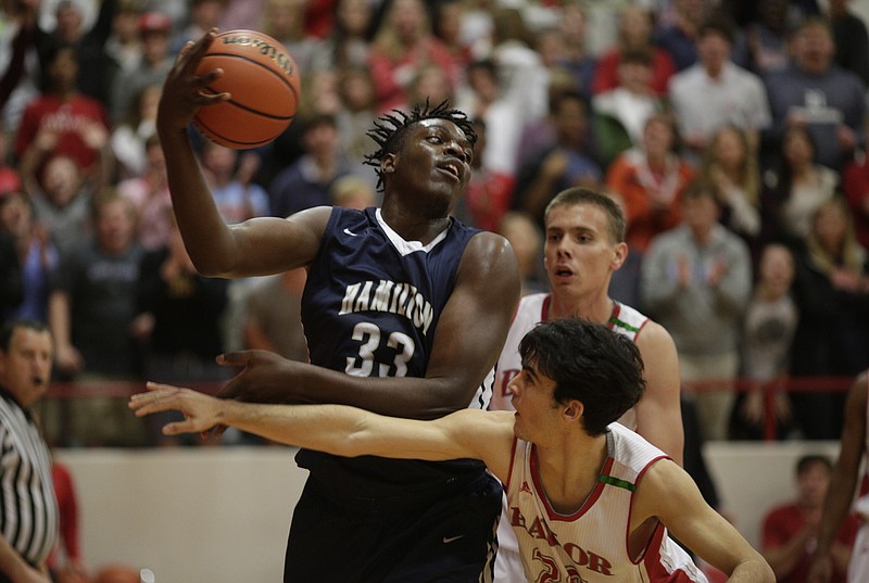 Hamilton Heights' Jason Jitoboh (33) rebounds against Baylor's Lorezno White during their prep basketball game at Baylor School on Tuesday, Dec. 5, 2017, in Chattanooga, Tenn.