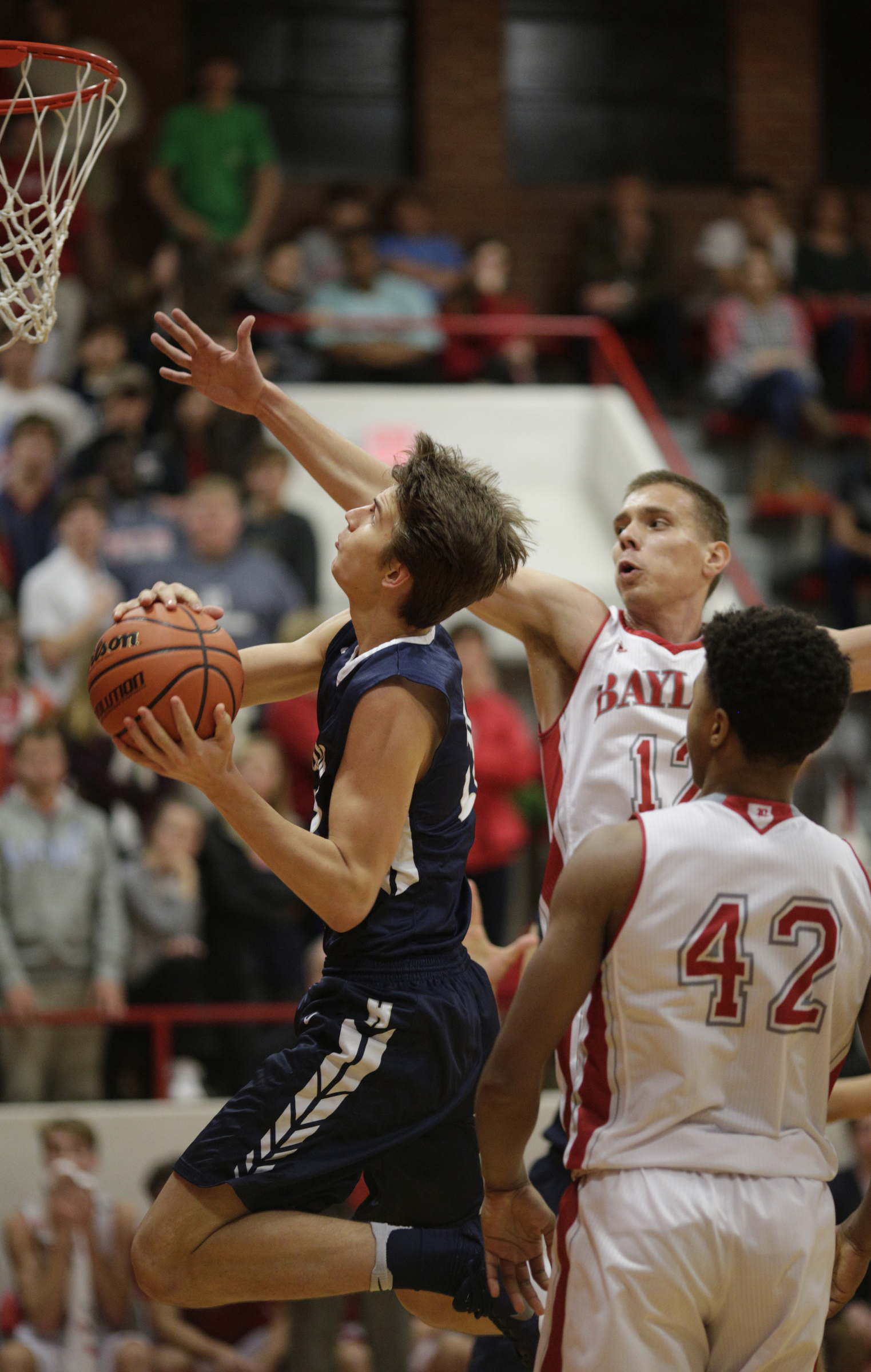 Hamilton Heights' Sam Ruzhentsev, left, shoots around Baylor's Boris Ristanovic (12) and Niko Simpkins (42) during their prep basketball game at Baylor School on Tuesday, Dec. 5, 2017, in Chattanooga, Tenn.