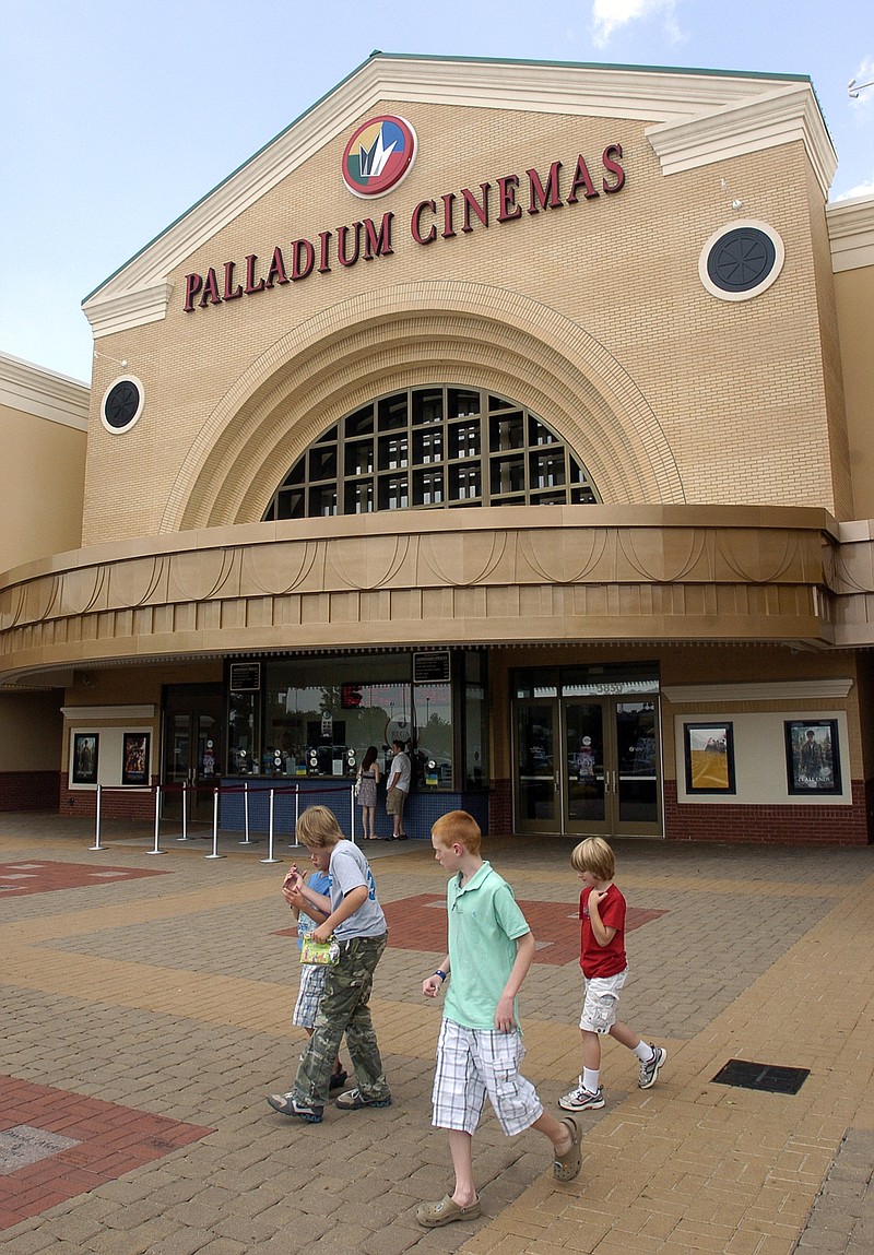 
              FILE - In this Tuesday July 26, 2011, file photo, people walk past Regal Entertainment's Palladium Cinemas in High Point, N.C. Cineworld is paying $3.61 billion for Regal Entertainment as it expands its global footprint. Cineworld has theaters in several nations, while Regal operates theaters throughout the U.S. (Don Davis Jr./The High Point Enterprise via AP, File)
            