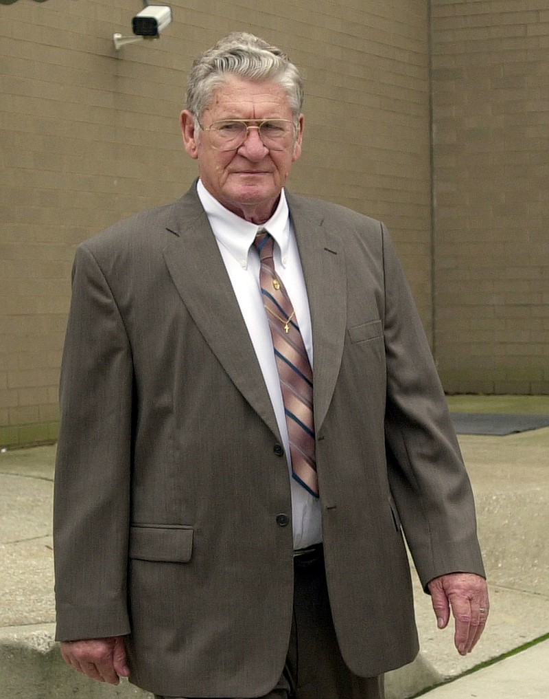 In this May 6, 2002 file photo, defendant Bobby Frank Cherry exits the rear door of the Jefferson County Criminal Justice Center during a lunch break in his trial. Convicted of murder in the deadliest attack of the civil rights era, the old Ku Klux Klansman didn't hesitate when the judge asked if he had anything to say before going to prison for a church bombing which killed four black girls in 1963. On cue, Bobby Frank Cherry pointed at a prosecution table that included Doug Jones. Fifteen years after Cherry snarled at Jones across a courtroom, the bombing is echoing in Alabama's fractious Senate race. (AP Photo/Dave Martin, File)