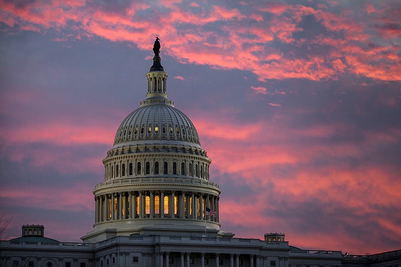 In this Thursday, Nov. 30, 2017, file photo, the sky over The Capitol is lit up at dawn as Senate Republicans work to pass their sweeping tax bill, in Washington. Congress' last major tax overhaul, three decades ago, was everything this year's version isn't. The Tax Reform Act of 1986 won bipartisan support. Its benefits flowed more to low- and middle-income taxpayers than to wealthy individuals and corporations. And it added nothing to the federal deficit. None of that can be said for tax-cut package the Senate passed after the House approved a similar version. (AP Photo/J. Scott Applewhite, File)