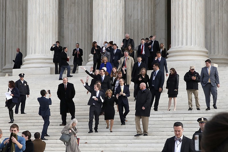 Jack Phillips, center left and next to attorney Kristen Waggoner, waves to supporters as they leave the Supreme Court 'Masterpiece Cakeshop v. Colorado Civil Rights Commission' case, Tuesday, Dec. 5, 2017, in Washington. (AP Photo/Jacquelyn Martin)