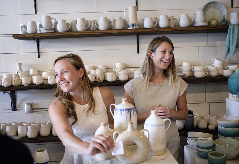 Katherine Hanks, left, and Stephanie Martin are co-owners of Annie Hanks Ceramics Studio on Main Street. They often produce functional pieces but, along with Shadow May, are hosting a show of fine art, "Convergence," through Dec. 23.