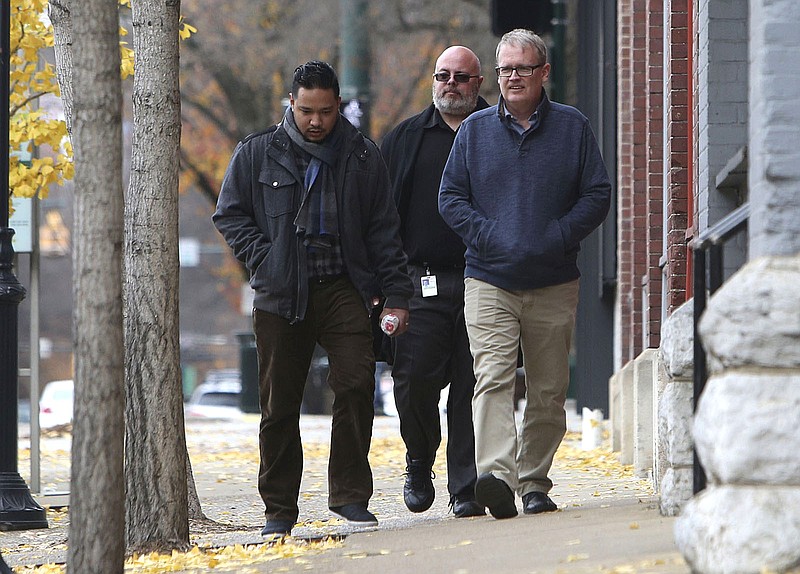 Daniel Mafnas, Darrell Duncan and Mike Smith walk along Market Street Wednesday, Dec. 6, 2017 in downtown Chattanooga, Tenn. The three Tennessee Valley Authority coworkers ventured out into the chilly weather to grab lunch and coffee before heading back to work. 
