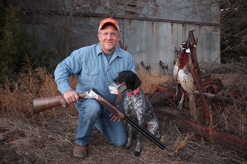 David Miller of CZ-USA firearms, who acted as the guide during outdoors columnist Larry Case's pheasant hunt in Greensburg, Kansas, in late 2017, poses with Mercy the bird dog.