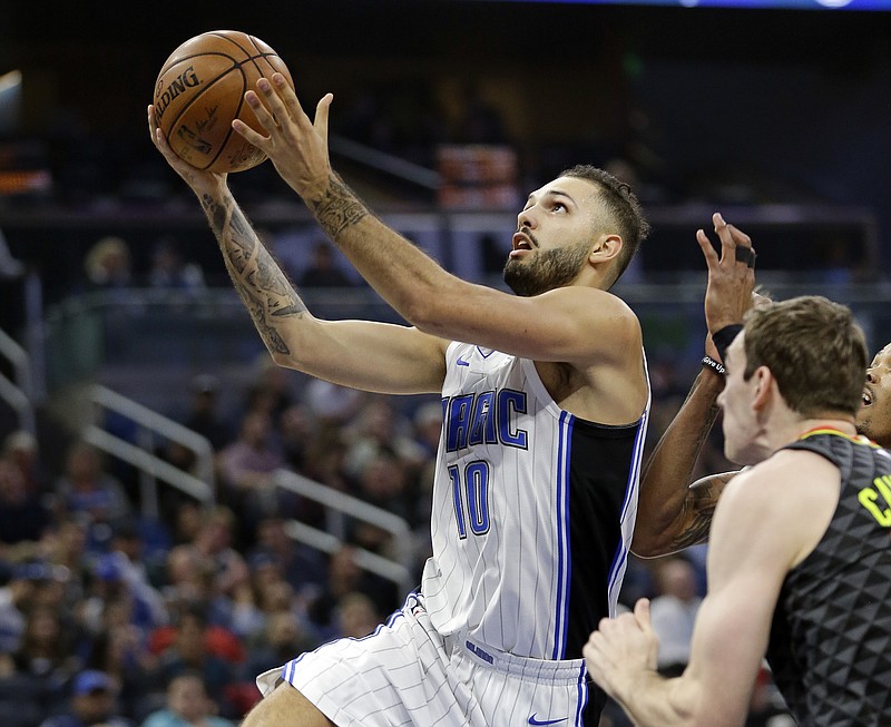 Orlando Magic's Evan Fournier (10) goes past Atlanta Hawks' Tyler Cavanaugh, right, for a shot during the first half of an NBA basketball game, Wednesday, Dec. 6, 2017, in Orlando, Fla. (AP Photo/John Raoux)