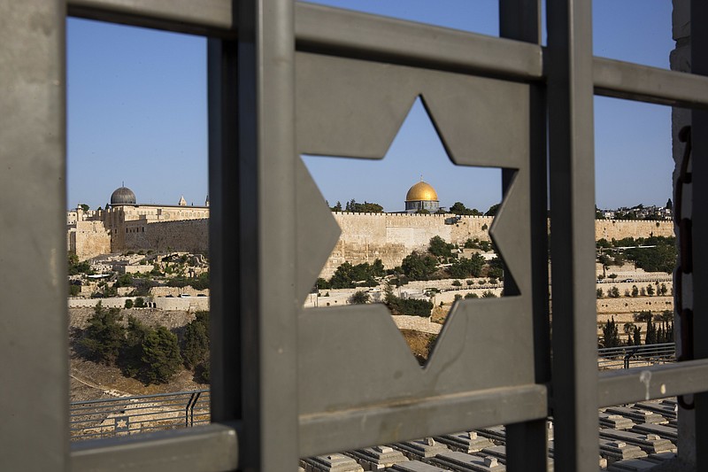 
              FILE - In this July 25, 2017 file photo, Jerusalem's Old City is seen trough a door with the shape of star of David. Turkey and the Palestinians have warned of dire diplomatic repercussions in the Middle East if President Donald Trump goes ahead with a possible recognition of the hotly contested Jerusalem as Israel's capital. The Arab League with almost two dozen member states was to discuss the controversy later Tuesday,
 Dec. 5, 2017. (AP Photo/Oded Balilty, File)
            