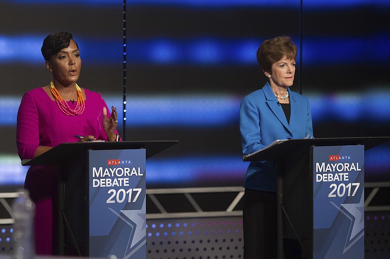 In this Dec. 3, 2017, file photo, Atlanta mayoral contenders Keisha Lance Bottoms, left, speaks as Mary Norwood listens at the WSB live debate in Atlanta. Voters in the Tuesday, Dec. 5, runoff for Atlanta mayor are deciding between Norwood and Bottoms. (Steve Schaefer/Atlanta Journal-Constitution via AP, File)