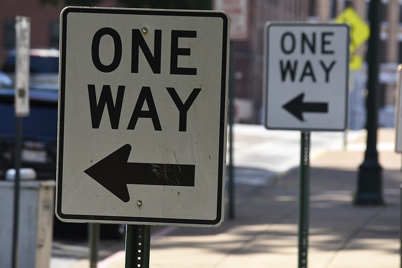 One-way signs direct motorists at the corner of Walnut and 6th streets in downtown Chattanooga.