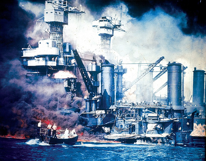 In this Dec. 7, 1941, file photo, a small boat rescues a USS West Virginia crew member from the water after the Japanese bombing of Pearl Harbor, Hawaii.