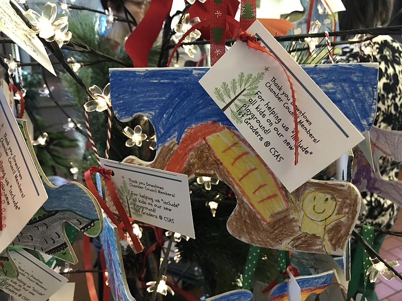 First graders at the Chattanooga School for Arts and Sciences decorated puzzle-shaped Christmas ornaments to help raise funds for improvements to their playground to make it more inclusive and accessible to their classmates with physical disabilities and special needs.