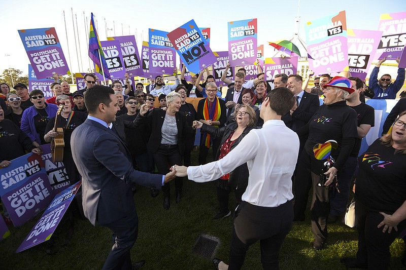 Same-sex marriage campaigners and volunteers cheer as they call on politicians to pass marriage equality legislation during rally outside Parliament House in Canberra, Australia, Thursday, Dec. 7, 2017. Gay marriage was endorsed by 62 percent of Australian voters who responded to a government-commissioned postal ballot by last month. (Lukas Coch/AAP Image via AP)