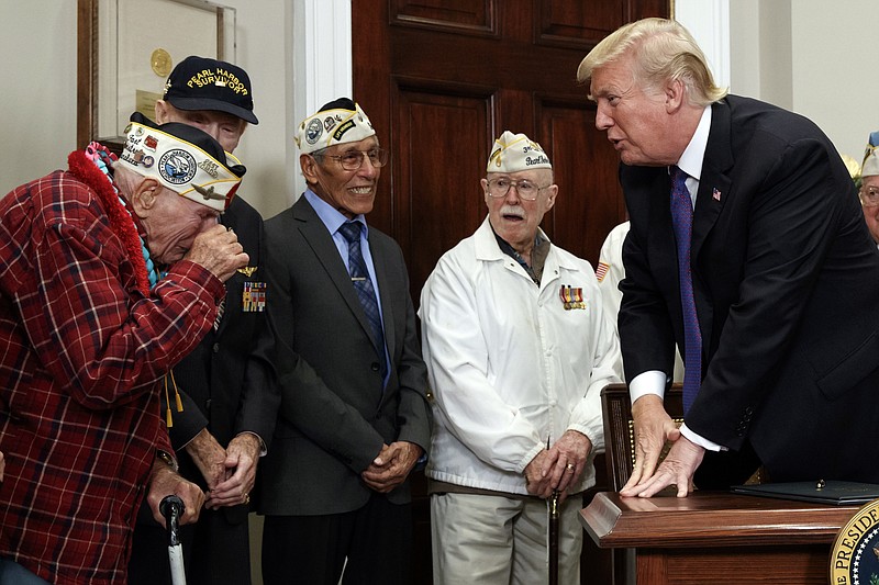 Lawrence Parry, left, wipes away a tear as he meets President Donald Trump during an event with Pearl Harbor survivors in the Roosevelt Room of the White House, Thursday, Dec. 7, 2017, in Washington. (AP Photo/Evan Vucci)