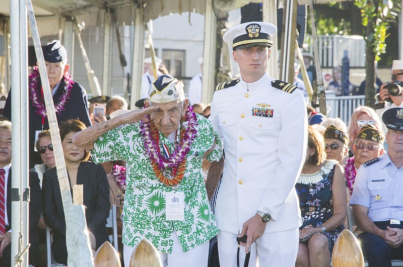 Pearl Harbor survivor, Al Rodrigues salutes for the audience during a ceremony at the Arizona Memorial in Honolulu, Hawaii., Thursday, Dec. 7, 2017. Survivors gathered Thursday at the site of the Japanese attack on Pearl Harbor to remember fellow servicemen killed in the early morning raid 76 years ago, paying homage to the thousands who died with a solemn ceremony marking the surprise bombing raid that plunged the U.S. into World War II. (Craig T. Kojima /The Star-Advertiser via AP)