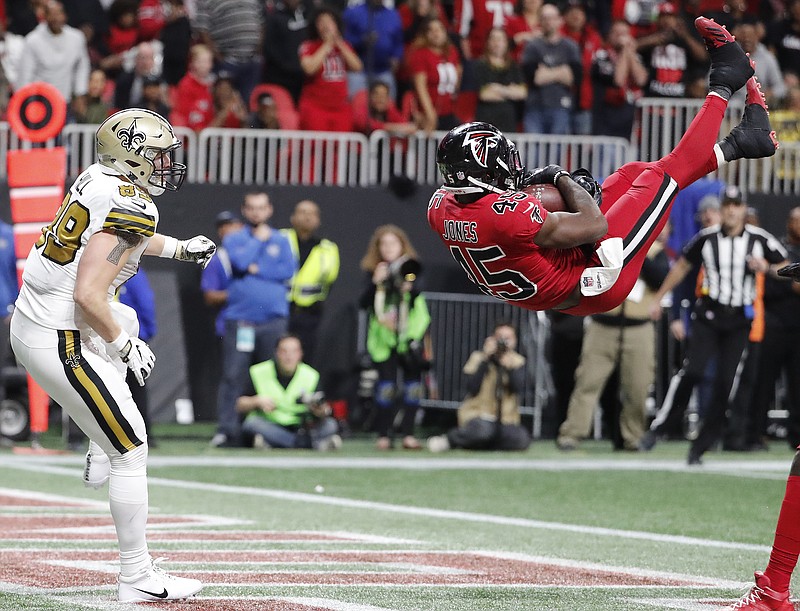Atlanta Falcons middle linebacker Deion Jones (45) intercepts a ball in the end zone ahead of New Orleans Saints tight end Josh Hill (89) during the second half of an NFL football game, Thursday, Dec. 7, 2017, in Atlanta. The Falcons won 20-17. (AP Photo/David Goldman)