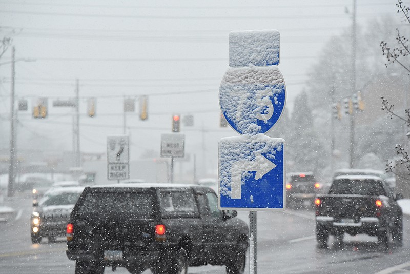 An Interstate 75 sign is covered in snow Friday morning at the intersection of Walnut Avenue and Thornton Avenue.
