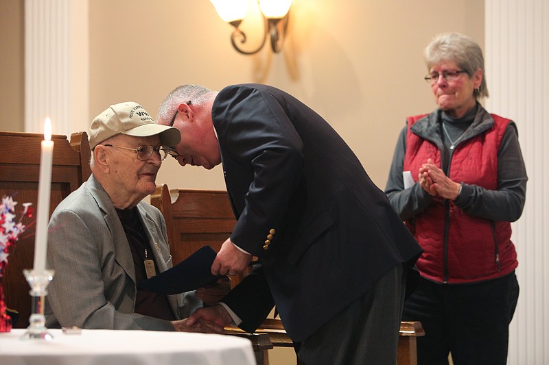 Pfc. George Allen accepts a proclamation from State Rep. Kevin Brooks as Allen's daughter Janet Allen stands by during Bradley Countyճ annual Pearl Harbor Remembrance Day Thursday, Dec. 8, 2017 at the Bradley County Elks Lodge in Cleveland, Tenn. Pfc. Allen is a survivor of Pearl Harbor. 