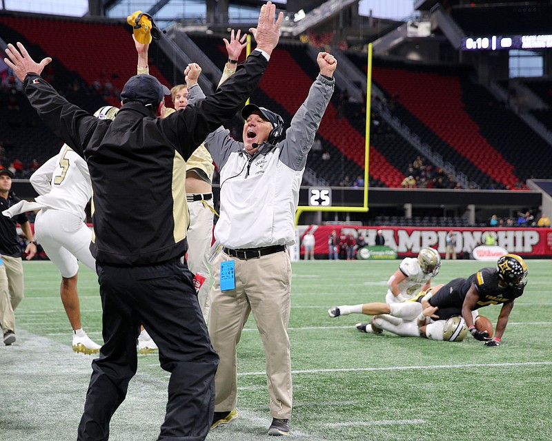 Calhoun football coach Hal Lamb celebrates as his team stops Peach County on its final possession of the Georgia Class AAA state championship game Friday at Mercedes-Benz Stadium in Atlanta. Calhoun won 10-6.