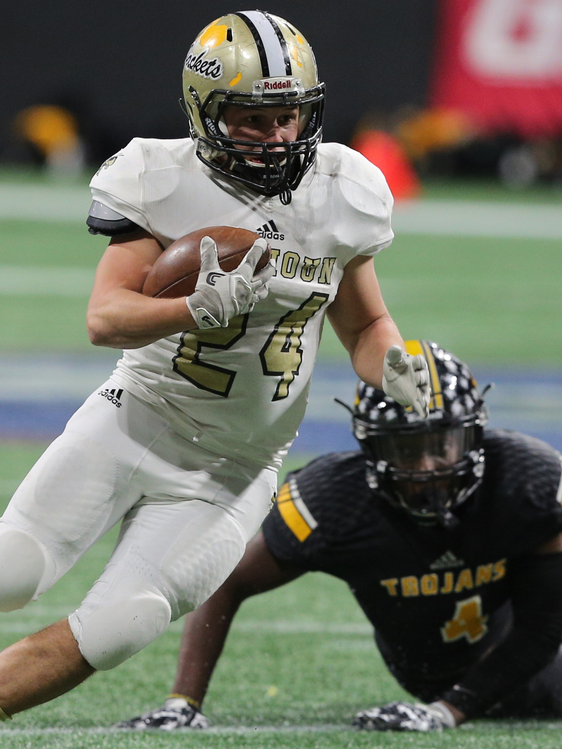 Calhoun running back Zack Fuller (24) avoids a tackle by Peach County's Jaquez Jackson during the GHSA Class AAA state championship game Friday in Atlanta. Calhoun won 10-6.